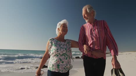Seniorenpaar-Geht-Gemeinsam-Am-Strand-Spazieren