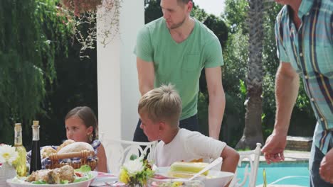 Happy-family-eating-together-at-table