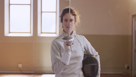 Female-fencer-athlete-during-a-fencing-training-in-a-gym