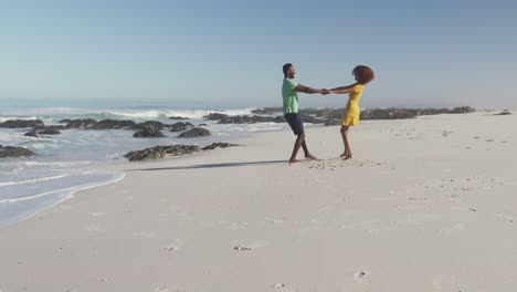 African-American-couple-playing-seaside