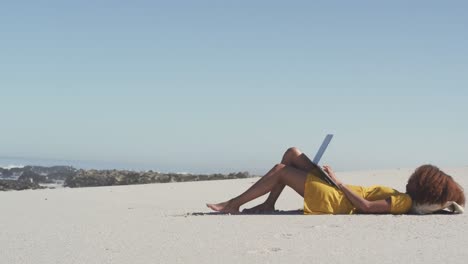 African-American-using-her-laptop-at-beach