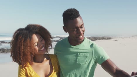 African-American-couple-taking-selfie-seaside