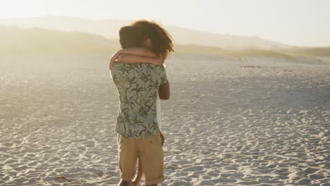African-American-couple-hugging-at-beach-