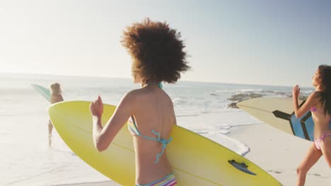 Mixed-race-women-ready-to-go-surf-