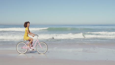 African-American-woman-riding-a-bike-seaside