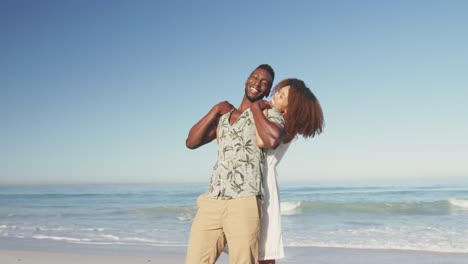 African-American-couple-man-cuddling-seaside