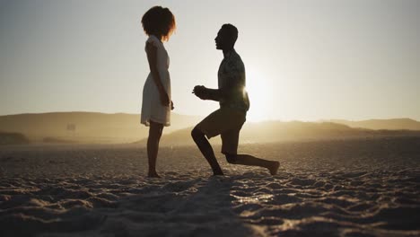 African-American-man-proposing-wedding-at-beach