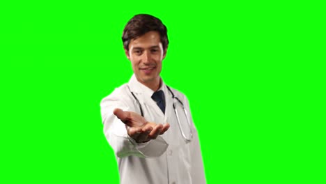 Vorderansicht-Eines-Arztes,-Der-Seine-Hand-Für-Einen-Kopierraum-Mit-Grünem-Bildschirm-Hält