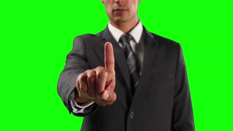 Mid-section-of-a-Caucasian-man-touching-the-screen-with-green-screen