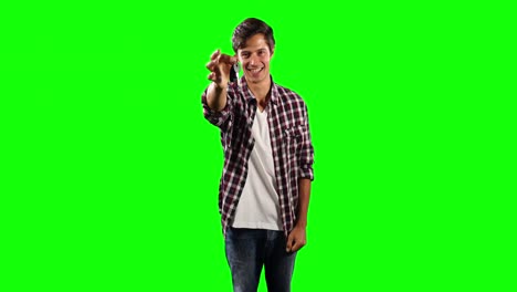 Front-view-of-a-Caucasian-man-holding-car-keys-with-green-screen