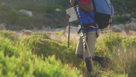 Mixed-race-man-with-prosthetic-leg-hiking-in-nature