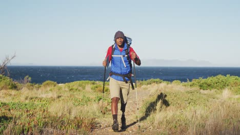 Mixed-race-man-with-prosthetic-leg-hiking-in-nature