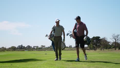 Golfistas-Varones-Caucásicos-Hablando-En-Un-Campo-De-Golf-En-Un-Día-Soleado