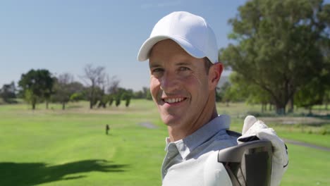 Caucasian-male-golfer-smiling-at-camera-on-a-golf-course