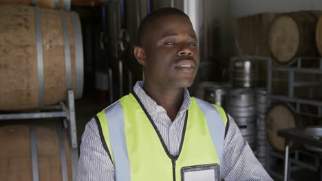 African-American-man-smiling-at-camera-and-wearing-high-visibility-vest