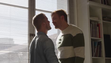 Caucasian-male-couple-in-social-distancing-at-home