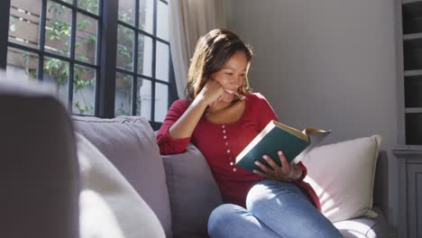 Mixed-race-woman-reading-a-book.-Social-distancing-and-self-isolation-in-quarantine