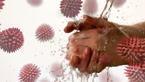Animation-Von-Makro-Coronavirus-Covid-19-Zellen,-Die-Sich-über-Einen-Mann-Ausbreiten,-Der-Seine-Hände-Unter-Wasser-Wäscht