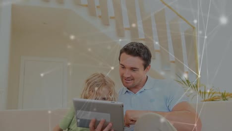 Animation-of-Caucasian-man-and-his-son-using-a-tablet-computer-with-a-network-of-moving-connections-