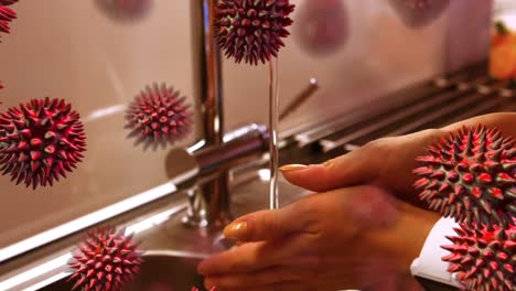 Animation-of-macro-coronavirus-Covid-19-cells-spreading-over-woman-washing-her-hands