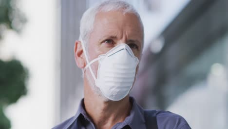 Caucasian-man-out-and-about-in-the-street-wearing-on-a-face-mask-against-coronavirus