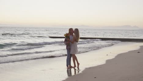 Caucasian-couple-enjoying-their-time-seaside