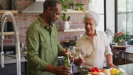 Senior-African-American-husband-and-mixed-race-wife-cooking-together-at-home