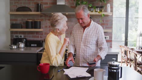 Senior-Caucasian-couple-working-together-at-home