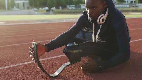 Disabled-mixed-race-man-with-prosthetic-legs-stretching-before-a-race-