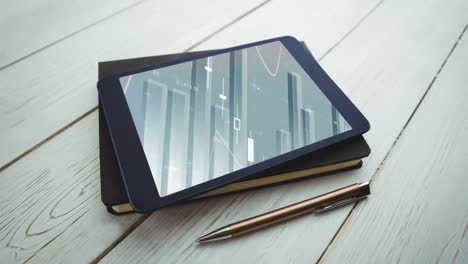 Animation-of-a-digital-tablet-lying-on-a-notebook-with-graphs-and-statistics-on-the-screen
