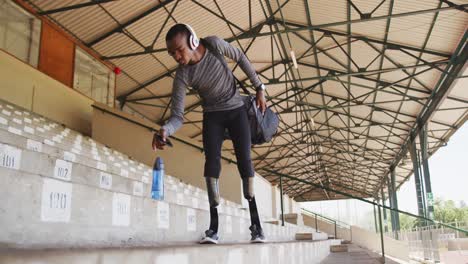 Disabled-mixed-race-man-with-prosthetic-legs-walking-down-the-stairs