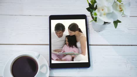 Animation-of-a-digital-tablet-showing-a-Caucasian-family-on-the-screen
