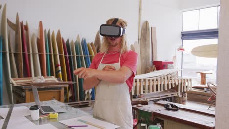 Caucasian-male-surfboard-makers-wearing-a-VR-headset