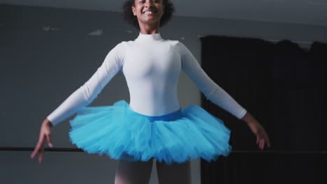 Mixed-race-female-ballerina--dancing-in-a-dance-studio