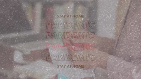 Animation-of-words-Stay-At-Home-Pandemic-over-Caucasian-woman-sewing-coronavirus-Covid19--masks