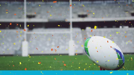 Animation-of-orange-and-yellow-confetti-falling-over-a-rugby-ball-lying-on-a-pitch