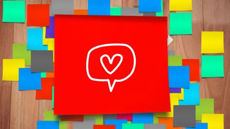 Animation-of-white-speech-bubble-and-heart-icon-flickering-on-red-sheet-of-paper-with-sticky-notes-s