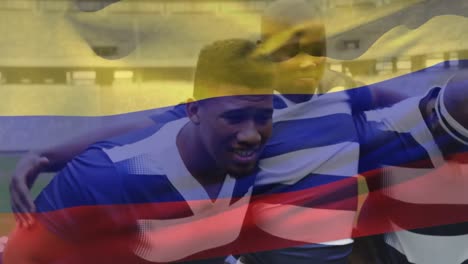 Animation-of-a-Colombian-flag-waving-over-multi-ethnic-male-rugby-team-standing-in-a-row