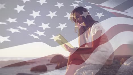 Young-caucasian-woman-on-computer-with-US-flag-waving-foreground