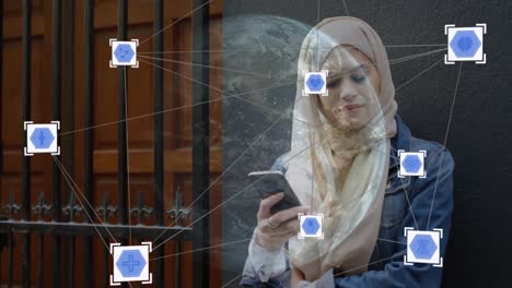 Red-De-Iconos-De-Conexiones-Y-Globo-Giratorio-Contra-Una-Mujer-Con-Hijab-Usando-Un-Teléfono-Inteligente