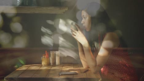 Glowing-spots-of-light-against-woman-drinking-coffee