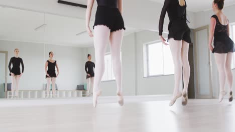 Caucasian-female-ballet-dancers-practicing-a-dance-routine-during-a-ballet-class