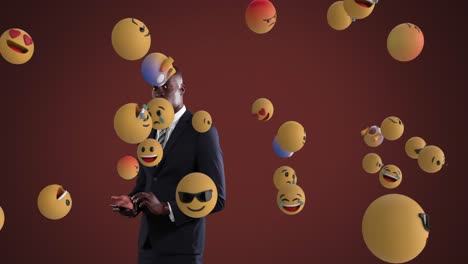 African-American-businessman-using-smartphone-with-emoticons-spawning