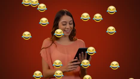 Face-emojis-moving-against-woman-using-digital-tablet