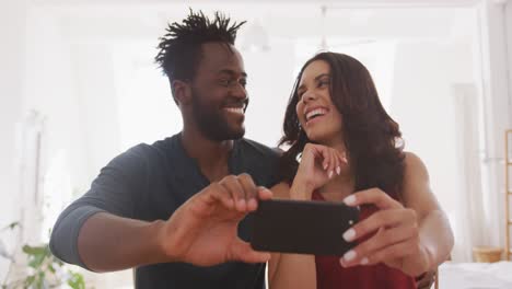 Happy-couple-taking-a-selfie-indoors