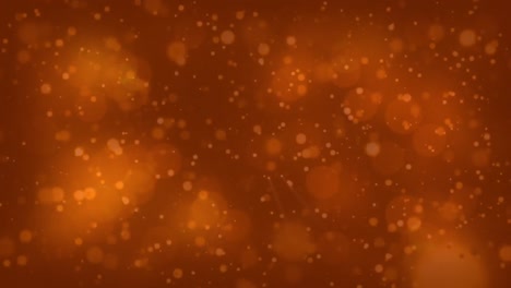 Digitally-generated-video-of-glowing-spots-moving-against-orange-background