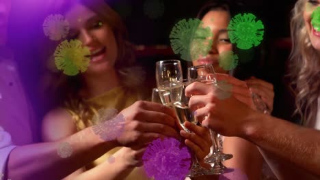 Digital-composite-video-of-covid-19-cells-moving-against-group-of-women-making-a-toast