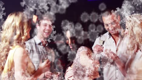 Digital-composite-video-of-Covid-19-cells-moving-against-group-of-people-holding-drinks-and-dancing-