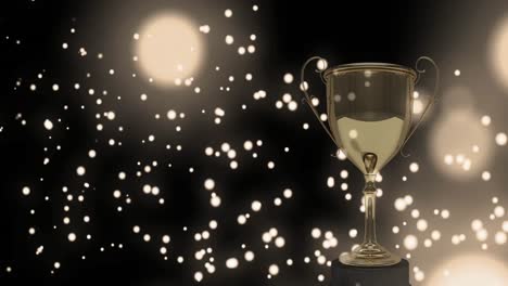 Yellow-glowing-spots-moving-against-golden-trophy-in-background