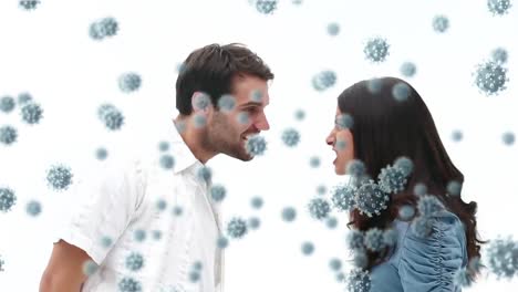 Digital-composite-video-of-Covid-19-cells-moving-against-couple-making-funny-faces-in-background